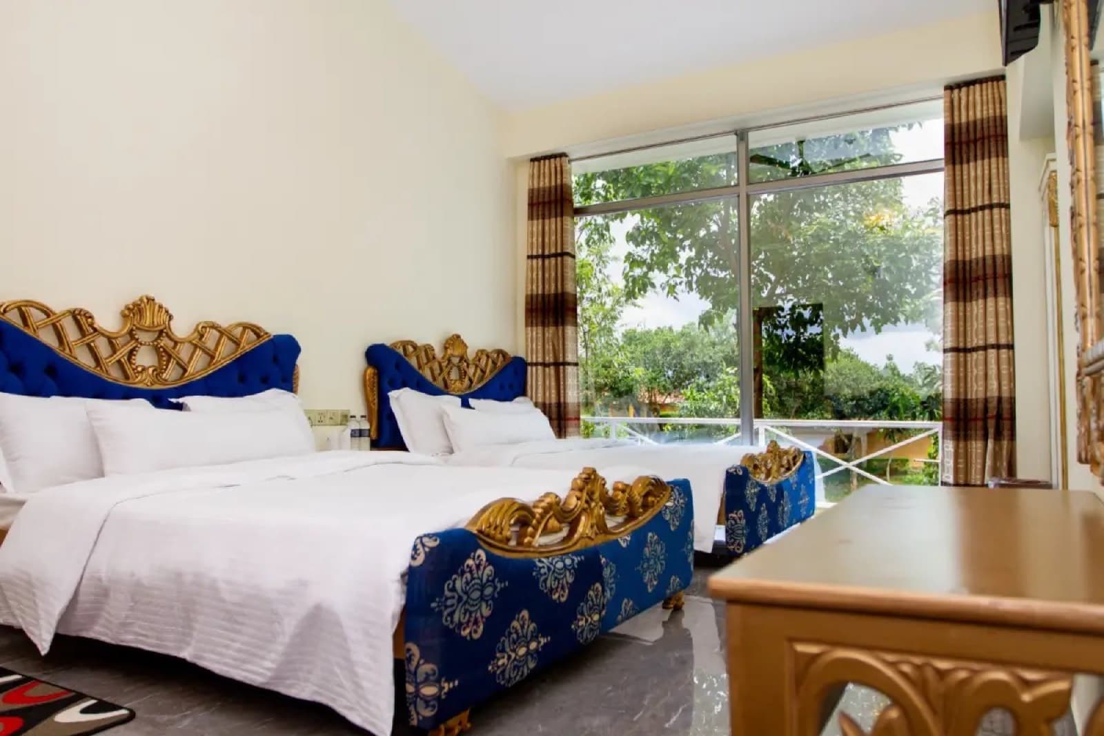 A Family Executive room at Novem Eco Resort with twin beds and a garden-facing window